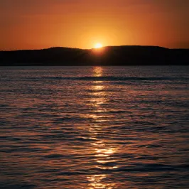 a sunset over a body of water